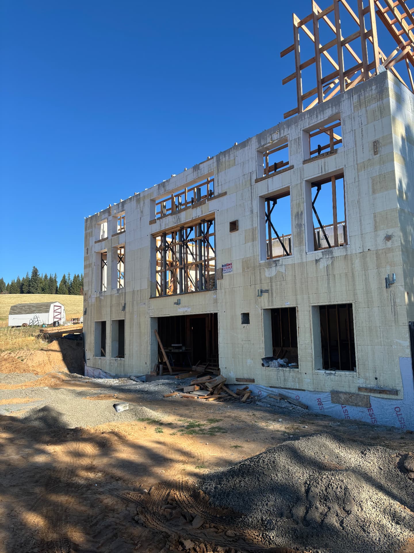 Building under construction with structural steel plates and brackets set into the walls