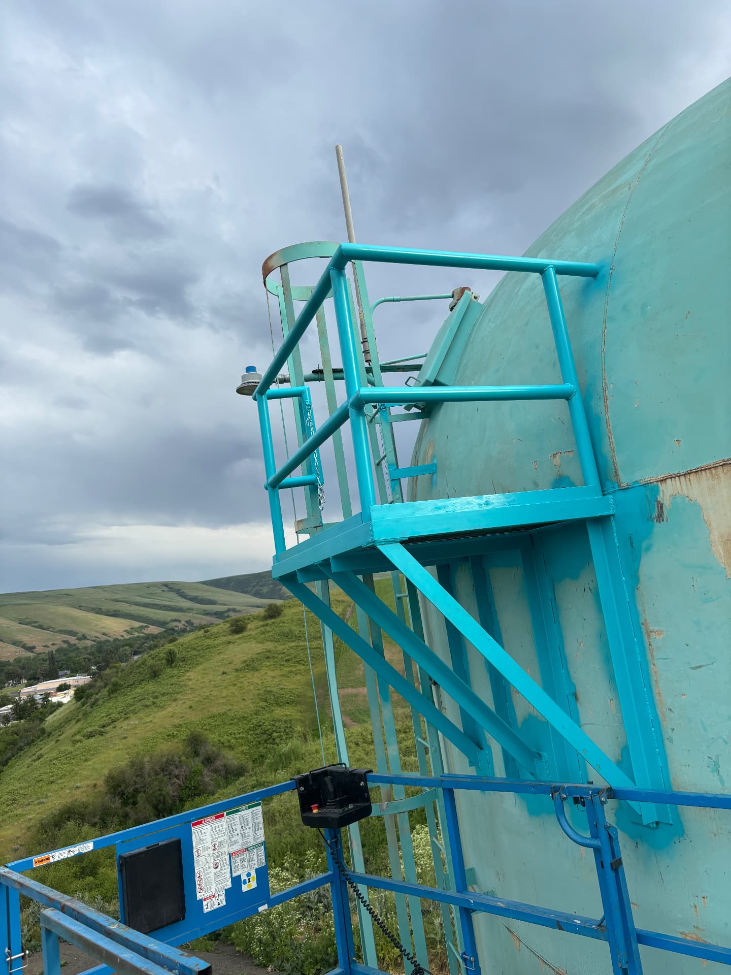 Ladder, cage, and work platform built on site at a water storage tank