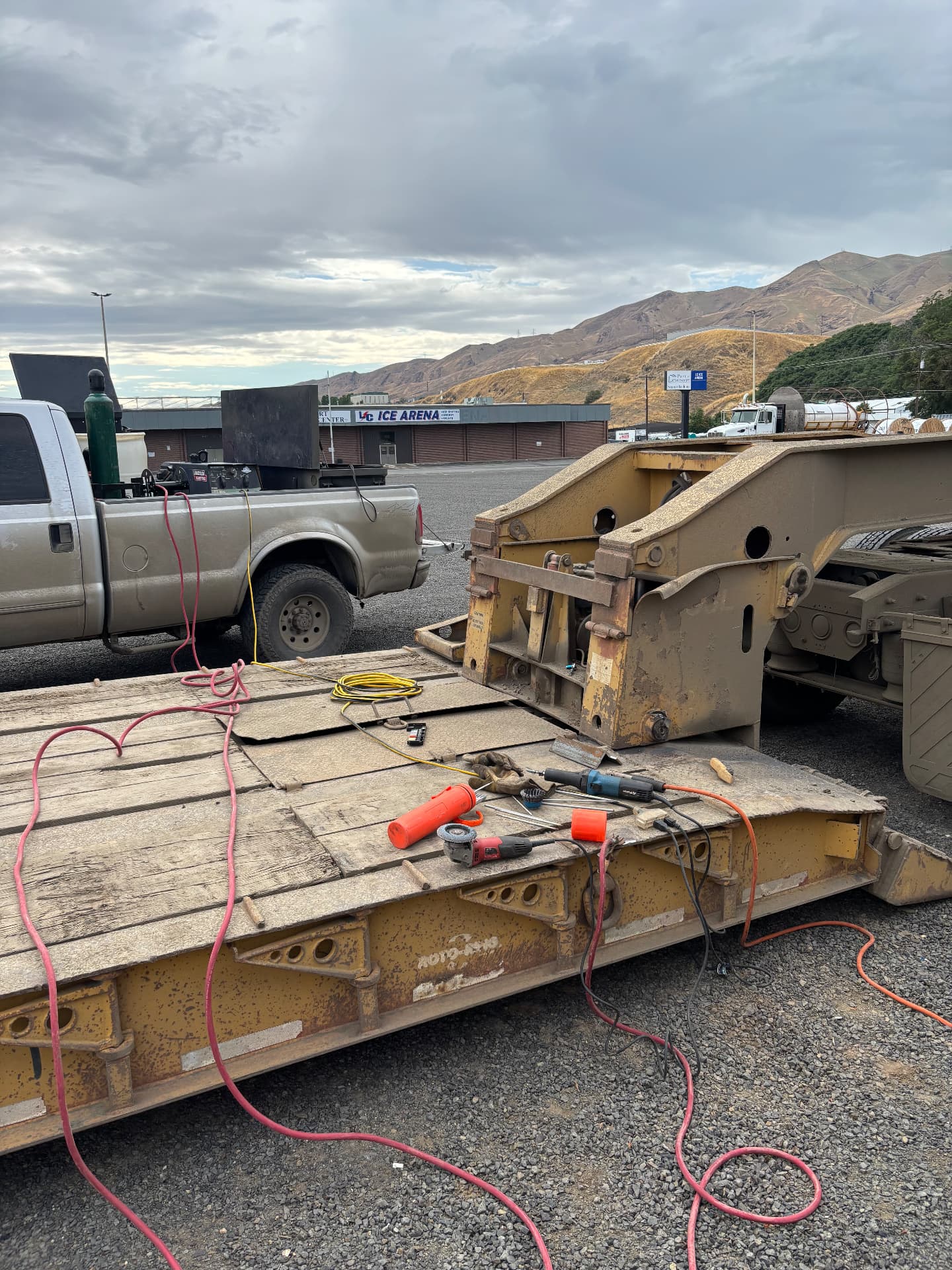 Mobile welding rig set up on the deck of a heavy equipment trailer