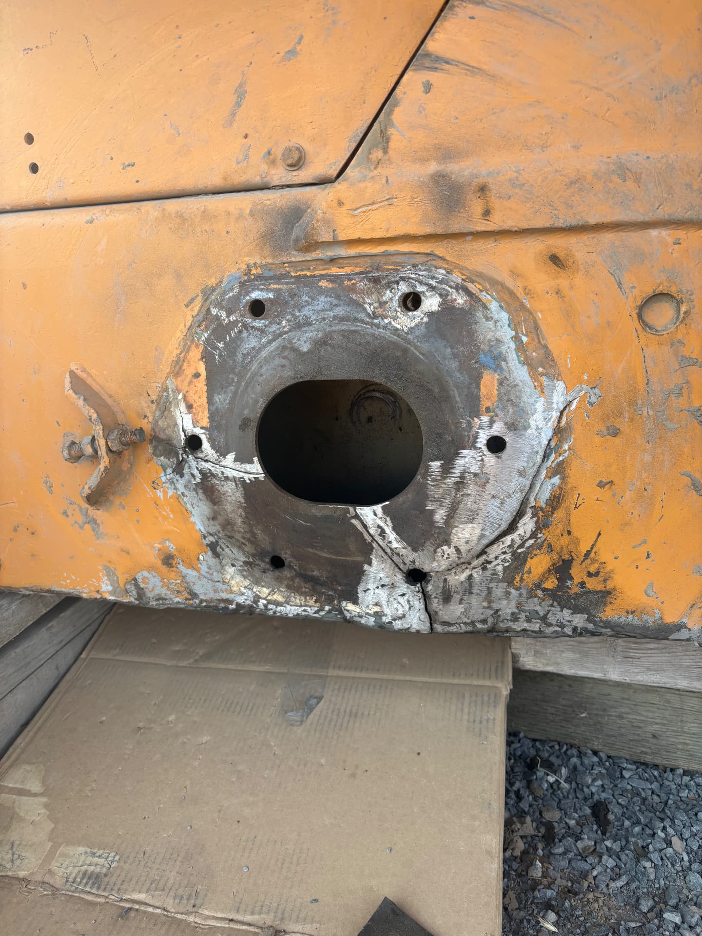 Cracked mounting area on heavy equipment prepared for welded repair